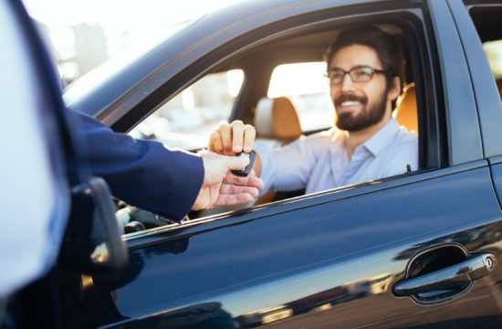 man with a car key 550x360 at Can You Afford to Buy a New Car?