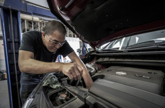 man working on a car 550x360 at 9 Regular Car Maintenance Tips to Keep Your Vehicle in Good Shape