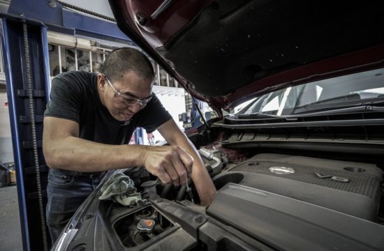 mechanic working 550x360 at 12 Key Maintenance Tips To Keep Your Car In Shape