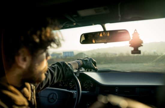 man inside a car with reflection on rear view mirror 550x360 at The certain challenges that come as a delivery driver
