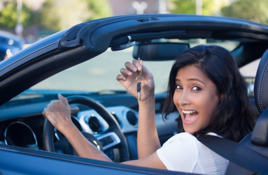 happy girl inside car 550x360 at When Is the Best Time to Buy a Car? A Simple Guide